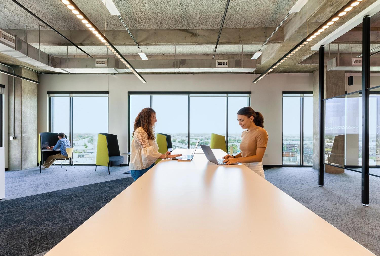 Two women working at a standing table